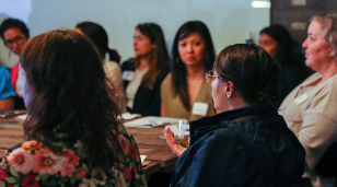 people sitting around the table talking about issues important to women.