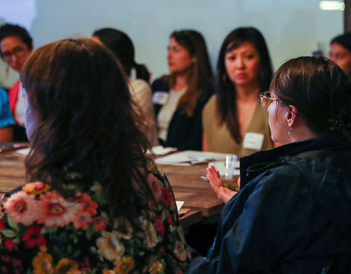 people sitting around the table talking about issues important to women.