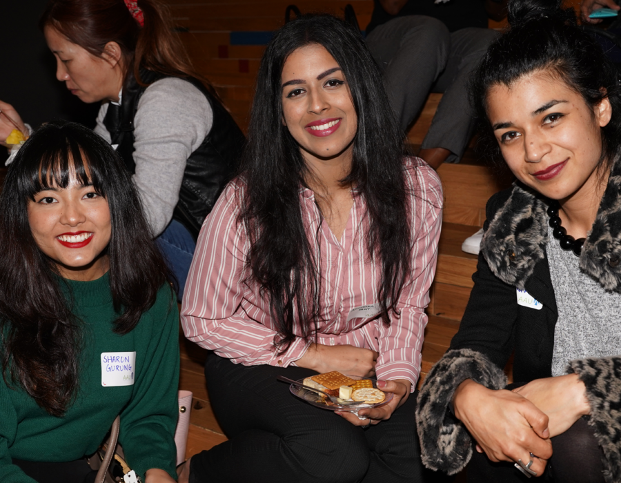 Three young women empower participants posing for the camera during a break in the workshop