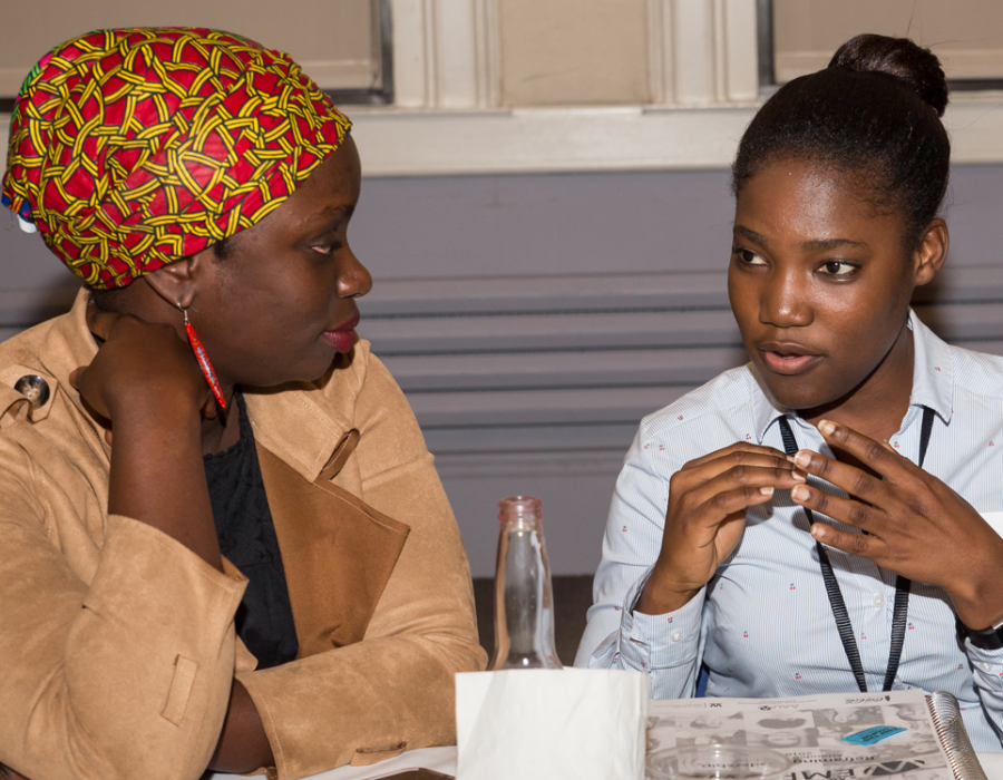Three young women empower participants chatting during a break in the workshop