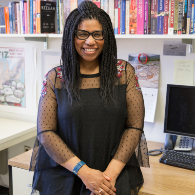 Photo of 2018-19 American Fellow Mary Phillips in front of a bookcase.