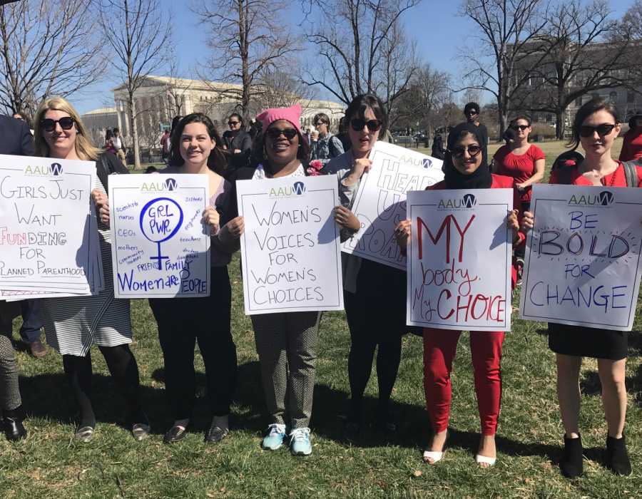 group of 7 young protesters near the U.S. Capitol holding signs encouraging the promotion of civil rights.