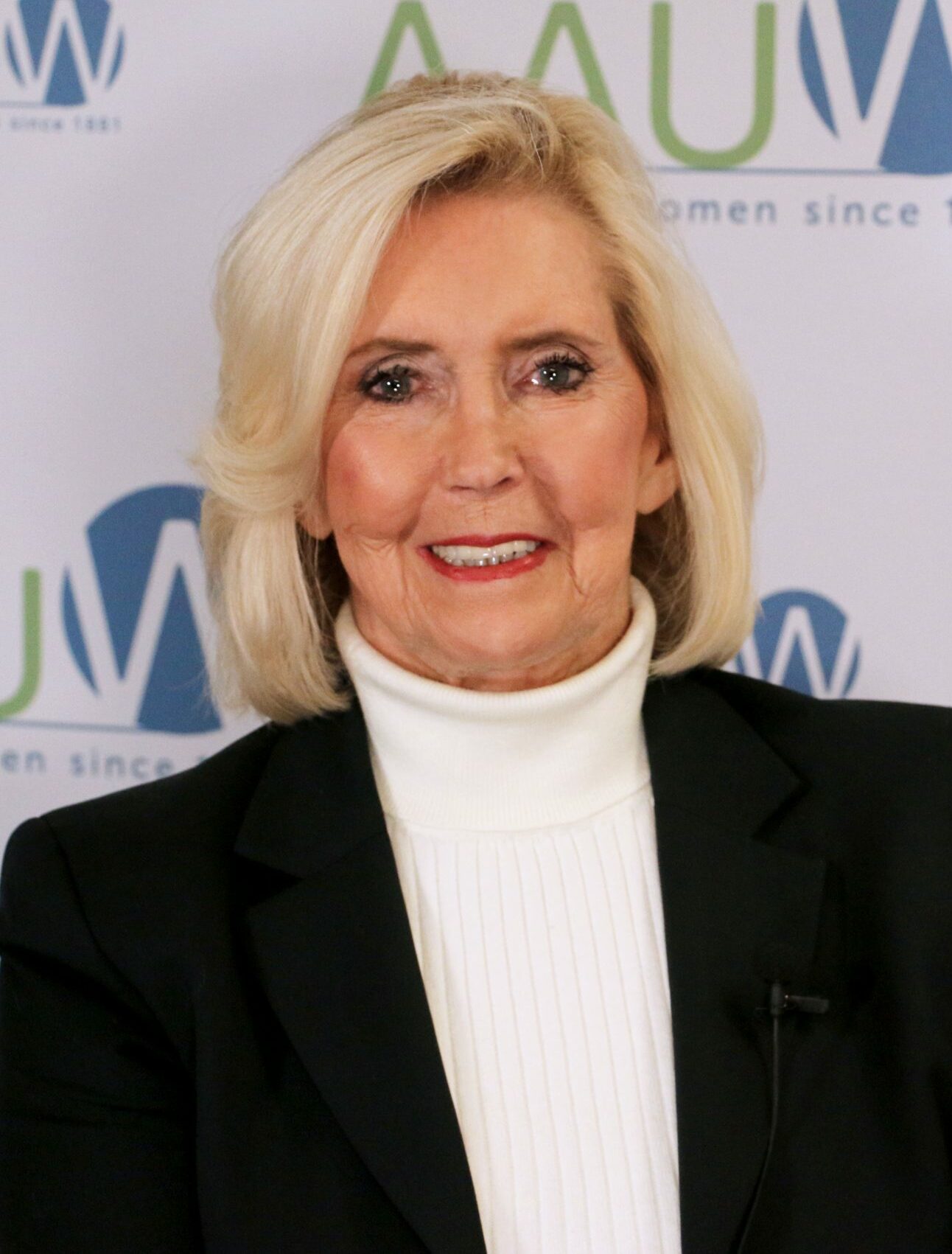 Photo of Lily Ledbetter in front of AAUW logo backdrop