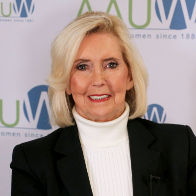 Photo of Lily Ledbetter in front of AAUW logo backdrop