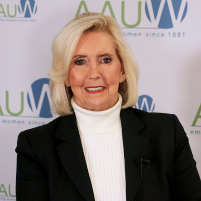 Photo of Lily Ledbetter in front of AAUW logo backdrop