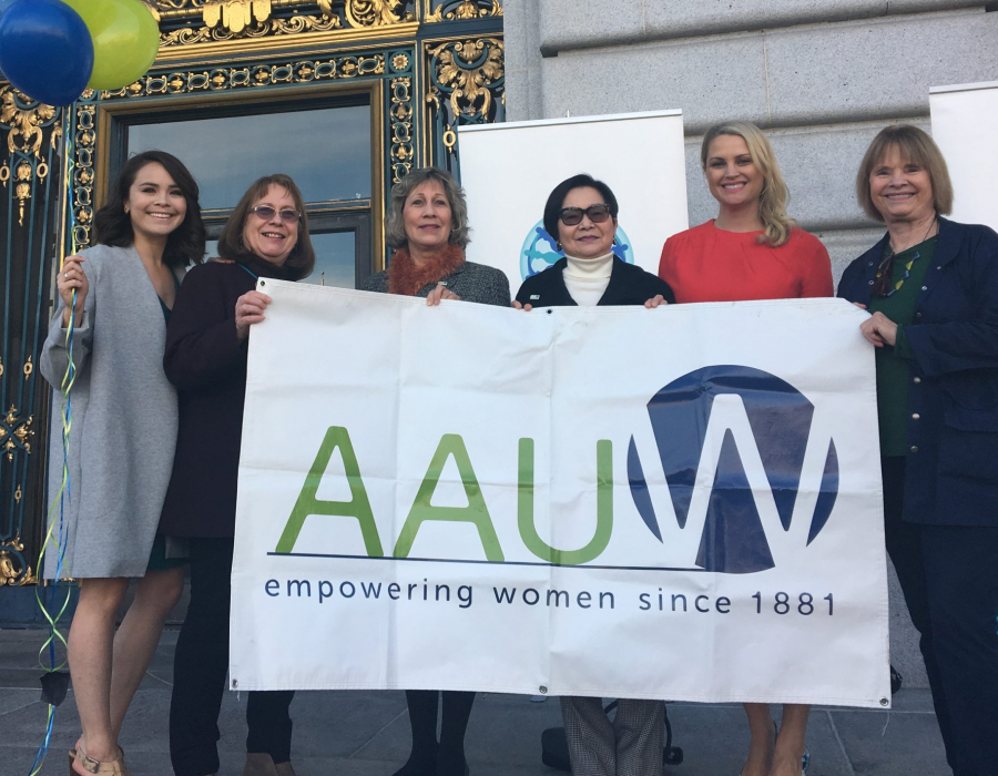 AAUW members holding a sign