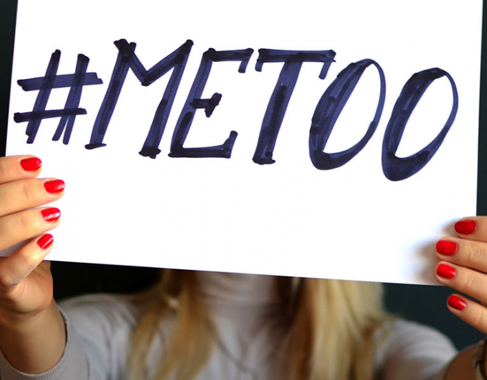 Hands holding #MeToo sign