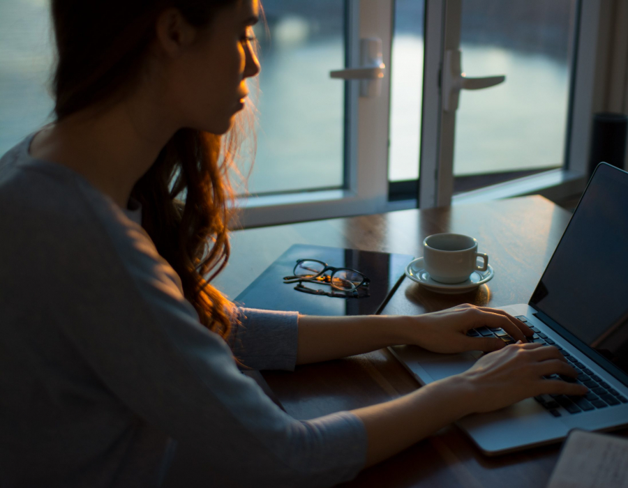 Woman typing on a computer. (Photo by Thought Catalog on Unsplash)