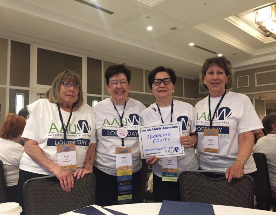 Four AAUW members with Lobby Day signs, including board member Cherie Sorokin