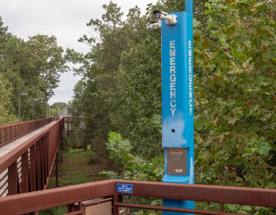 Emergency blue light on campus in quiet wooden foot path area