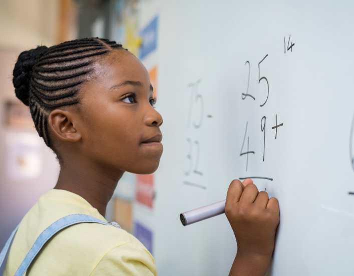 Girl at blackboard solving equation