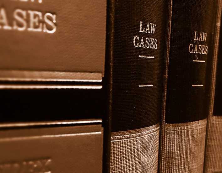 bookshelf full of leather-bound books that are titled