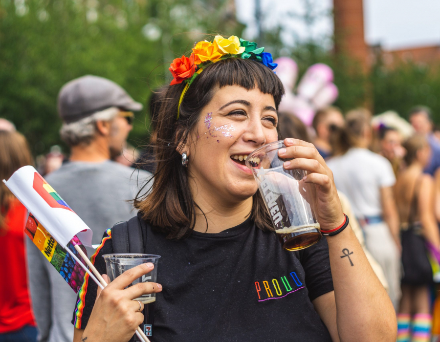 Image of Hispanic woman at LGBTQ event wearing Pride colors and t-shirt. Photo by Jose Maria Sava