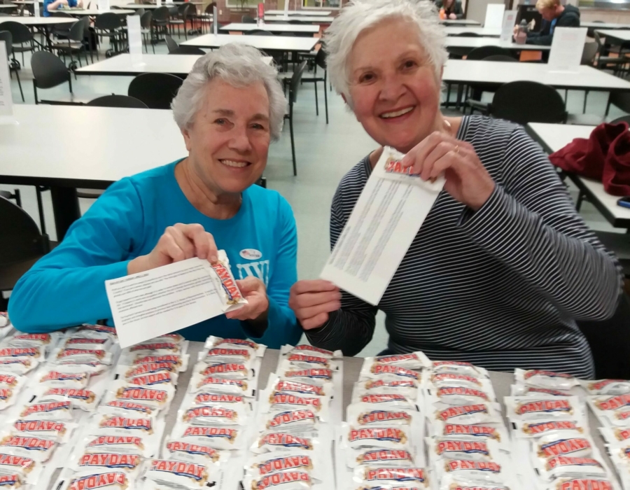 AAUW Appleton members Conney Polley and Rachel Edwards De Moss handing out a thousand Payday candy bars on an Equal Pay Day event on March 2019