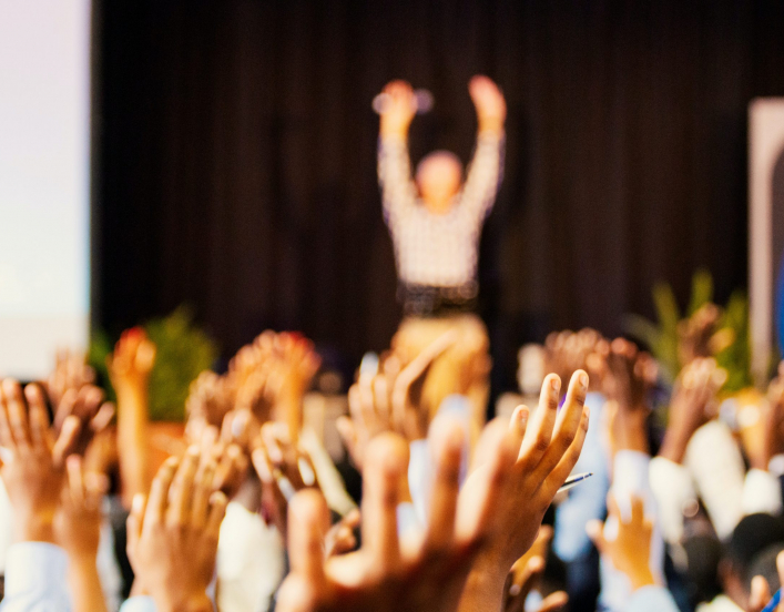 hands raising at a conference