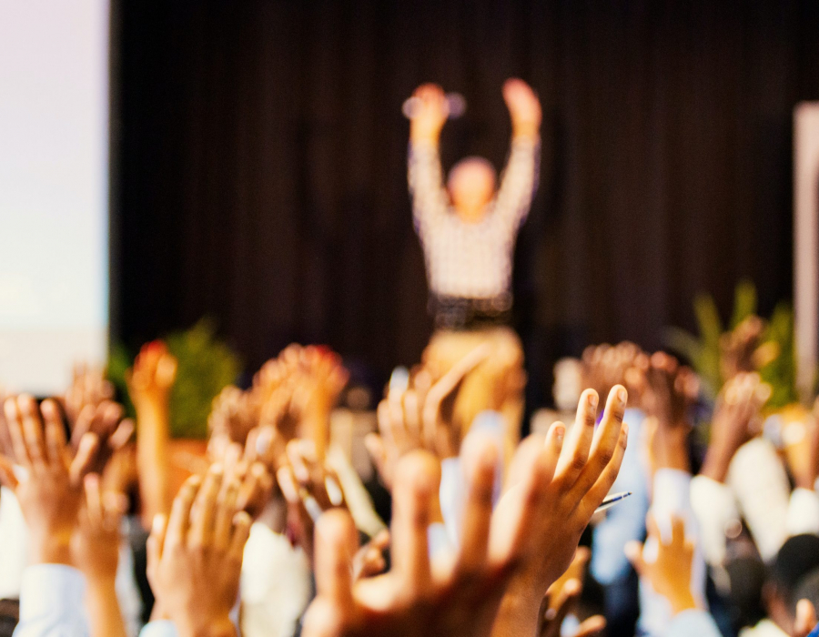 hands raising at a conference