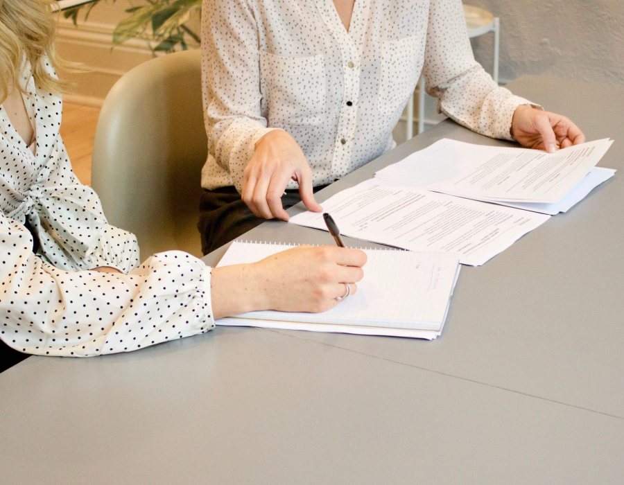 Two women editing a resume together