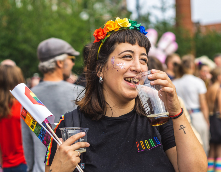 Image of Hispanic woman at LGBTQ event wearing Pride colors and t-shirt. Photo by Jose Maria Sava